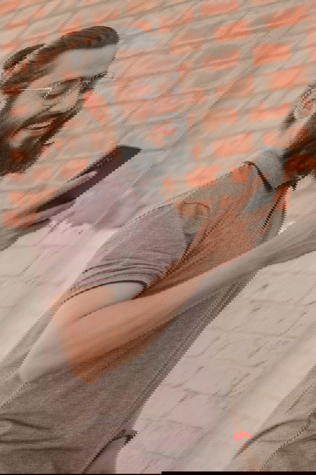 a man with a beard using a cell phone